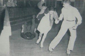 One skater falls while two scurry out of the way at Dixieland Roller Rink. The rink was destroyed by fire sometime after the 1950s.