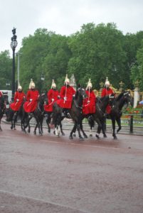 Mounted guards outside of Buckingham Palace make their way to the gate in preparation for the changing of the guard there.