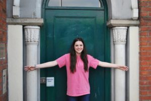 Kiefer High freshman Sierra Lee spans the width of the smallest house in Dublin, Ireland. Though three stories tall, it is less than 12 feet wide.