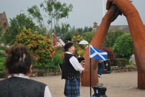 A bagpiper plays near the flag bearing St. Andrew's Cross, patron saint of Scotland, as part of the British Queen Elizabeth II's birthday celebration at Edinburgh Castle..