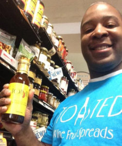 Corey Carolina holds one of his Toasted Spreads, just off the shelf of a local grocery store.