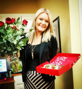 Lacy Taylor with roses and chocolates she received from Randal Arnold while he is overseas serving in the Air Force.