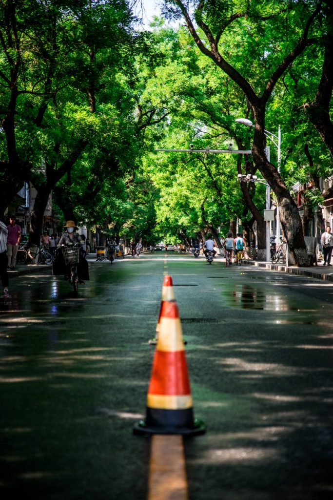 two red and white traffic cones in middle on road