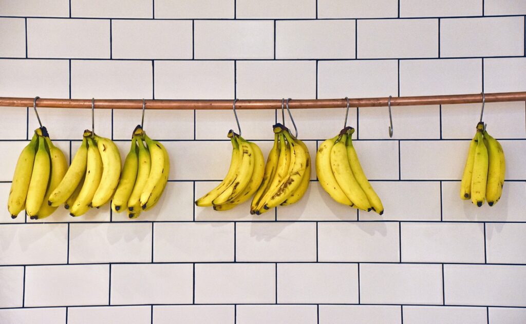 A banana hanger decorating a white wall.