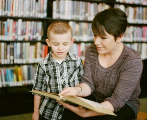 Mother reading to her son as he listens intently. Books in the background are slightly blurred creating the perfect atmosphere to instill a lifelong love of reading. The 3 - 6 year old boy is engaged, happy, the moment is captured in this photo creating a lifelong memory. 

https://www.awcreativeut.com
https://www.instagram.com/AwCreativeUT/
https://www.citystorageif.com/
https://www.etsy.com/shop/AwCreativeUT

#AwCreativeUT #awcreative #AdamWinger